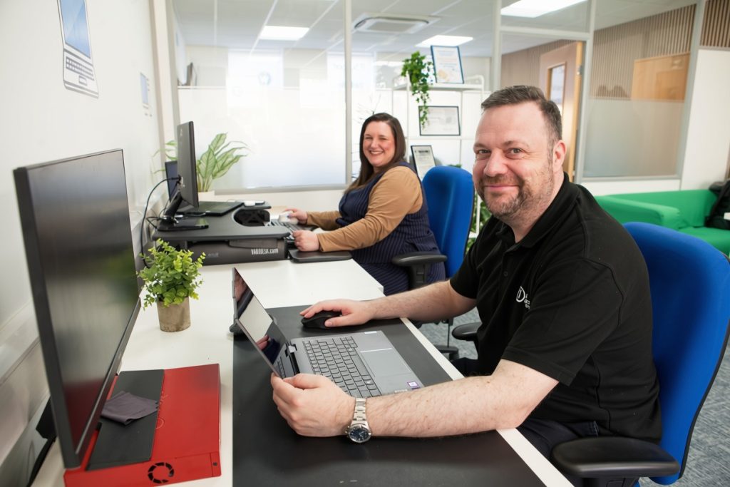 Information Solutions IT support engineers working at their desks in Shrewsbury